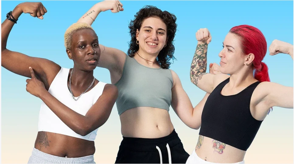 Burn your binders, Girls! Picture of three teenaged girls wearing binders, flexing their arms.