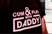 A person man a T-shirt that reads "CUM & PLAY WITH DADDY" in bold text across the chest at Ottawa Pride 2024