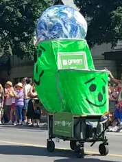A cart combining a Green Party of Canada-brand with a large oversized  green novelty Kool-Aid Man-style pitcher at Ottawa Pride 2024