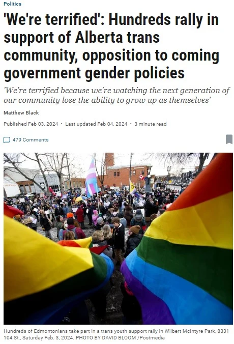 A screenshot of a news article webpage. At the top, a small blue category label reads "Politics," followed by a bold black headline: "'We're terrified': Hundreds rally in support of Alberta trans community, opposition to coming government gender policies." Below the headline, an italicized subheading/pull-quote reads: "'We're terrified because we're watching the next generation of our community lose the ability to grow up as themselves'." Below that, a byline reads "Matthew Black," followed by "Published Feb 03, 2024 • Last updated Feb 04, 2024 • 3 minute read" and "479 Comments" with a bookmark icon. Below the article metadata is a photograph taken from within a crowd, looking past large rainbow Pride flags being waved in the foreground toward a dense crowd of people gathered outdoors near brick buildings, with a light purple/pink and blue transgender pride flag also visible above the crowd. Below the photo, caption text reads: "Hundreds of Edmontonians take part in a trans youth support rally in Wilbert McIntyre Park, 8331 104 St., Saturday Feb. 3, 2024. PHOTO BY DAVID BLOOM /Postmedia."