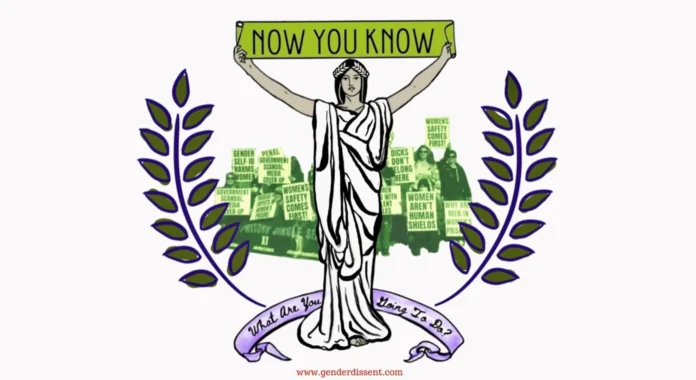 Piquing Canadians with truths about transgenderism at Civitas A woman holds a sign saying "now that you know" and banner by her feet says "what are you going to do about it?"