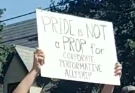 A handheld sign at Ottawa Pride 2024 reading "PRIDE IS NOT A PROP" in large bold capital letters, with smaller text below reading "Performative Allyship." 